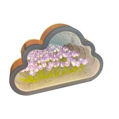 there is a flower arrangement in the shape of a cloud with flowers growing out of it