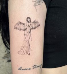 a woman's arm with a tattoo on it that has an angel holding a star