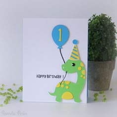 a birthday card with a dinosaur holding a balloon