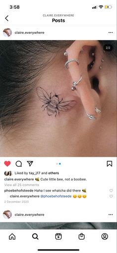 the ear has been tattooed with an image of a spider on it