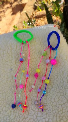 two bracelets with beads are sitting on a blanket