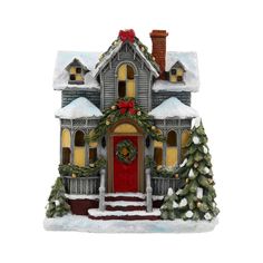 a christmas house ornament with wreaths and lights on the front door is shown