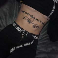 a woman with tattoos on her stomach and the words come out when you're dead