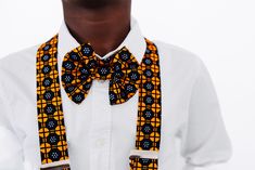 Seye - Honor Add a touch of cultural and stylish flair to your little boy's wardrobe with the Seye Adjustable Ankara Print Bow Tie and Suspender Set. Made with vibrant and durable Ankara fabric, this set is perfect for adding a pop of color to any formal or casual outfit. Elevate any look with this unique and versatile set. FEATURES: Unisex Ankara print Elastic extender 2 Piece Bow tie and suspender Set Pre-tied Adjustable Bow Tie measure 13" - 17.5" Small Suspender measure - 9" - 16" Large Suspender measure 12"- 23" Recommended Fit: Small fits Babies -Toddler Large fits 5 years and up Care Instructions: Remove stain with mild detergent and warm water. Hang to dry. Iron warm on reverse side. Do not bleach. Disclaimer: The fabric patterns on each item may differ from the picture due to the Fitted Cotton Sets For Gifts, Suspenders Set, Ankara Print, Ankara Fabric, African Fabric, Casual Outfit, Fabric Patterns, Ankara, Warm Water