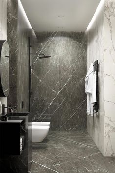 a bathroom with marble walls and flooring in black and white colors is pictured here