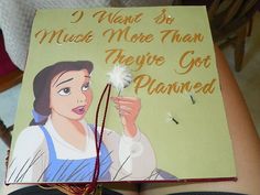 a book with an image of snow white holding a dandelion in her hand