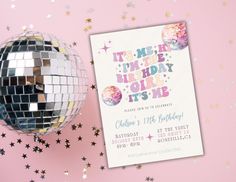 a disco ball next to a birthday card on a pink background with confetti and stars