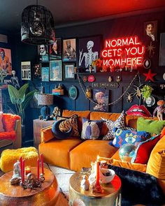 a living room filled with orange couches and colorful pillows on top of each other