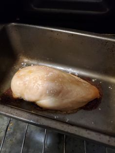 a piece of meat is being cooked in an oven