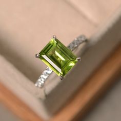 This ring features a 7*9mm natural peridot and sterling silver finished with rhodium. Customization is available. It is made by hand, and it will take about 7 days to finish the ring after your payment is completed. Any question, just let me know. :) My shop homepage: https://www.etsy.com/shop/LuoJewelry?ref=l2-shopheader-name Birthstone Wedding Band, Peridot Engagement Ring, Jewlery Rings, Peridot Engagement Rings, Silver Jewelry Diy, Peridot Jewelry, Emerald Cut Rings, August Birthstone, Diy Rings