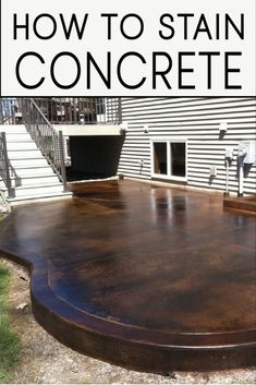 a large wooden table sitting in front of a house with the words how to stain concrete on it