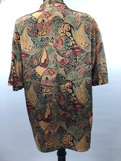 "Vintage 1980's silky marbleized print blouse. Deep V neck with four buttons and a snap at the bottom. Originally had a structured shoulder but the pads have been removed. No tags. Not lined. Most likely a rayon blend. The pattern is gorgeous and richly colored. Can be worn open or buttoned. It's slightly psychedelic but in an 80's palette. Slouchy lapel collar and faux chest pockets. Lots of hand sewn details, most likely made in the USA. Great vintage condition, no issues. Measured flat: Shoul Vintage Printed Silk Tops, Vintage Multicolor Silk Tops, Casual Silk Tops With Abstract Print, Vintage Silk Collared Top, Structured Shoulder, Bellingham Wa, Silky Blouse, Plant Dyes, Dyed Dress