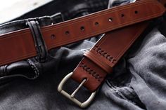 "These every day leather belts are made using thick, durable, full-grain harness leather from the Wickett & Craig tannery. Designed to be at your service for many years, they will take on a wonderful rich character with age. They're 1.5\" in width, with a tapered, low profile tail-end. Its hand-stitched construction is fitted with a solid brass buckle with a muted, satin-steel finish. For added comfort and durability, all edges are rounded and burnished smooth with a soft wax finish. Handcra Brown Bridle Leather Belts And Suspenders For Everyday, Rugged Leather Belt Buckles For Everyday Use, Rugged Belt Buckles With Leather Strap For Everyday Use, Rugged Brown Leather Belts And Suspenders, Brown Leather Belts For Everyday Use, Brown Leather Strap Belt Buckle For Everyday Use, Masculine Brown Belt For Everyday Use, Brown Belt For Everyday Use, Brown Leather Belt Buckles For Everyday Use