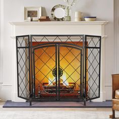 a fireplace with a fire in it next to a chair