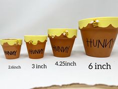 four plastic cups with writing on them sitting next to each other in different sizes and shapes