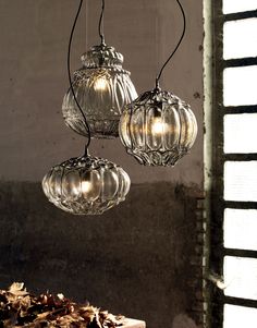 three clear glass hanging lights in a room