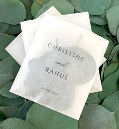 two napkins sitting on top of green leaves with the words, christine and rauh