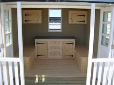 the inside of a tiny house with lots of windows and cupboards on the outside