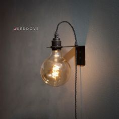 a light that is on the side of a wall with a cord attached to it