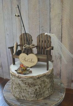 a wedding cake with a chair and fishing rod on top