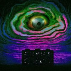 an eye is shown in the center of a computer keyboard and it appears to be glowing