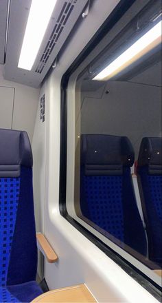 the inside of a train with blue seats