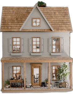 a doll house with furniture and decorations on the front door, windows, and porch