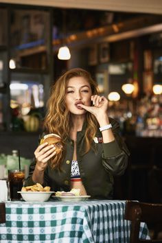 a woman sitting at a table eating food