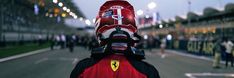 a person wearing a red and black helmet is standing in front of a line of people