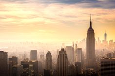 the skyline of new york city is shown in this photo from above at sunset or dawn