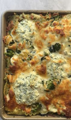 a casserole dish with broccoli and cheese