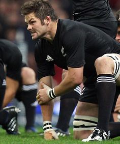 a rugby player kneeling down on the field