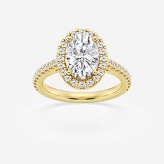 a yellow gold engagement ring with an oval cut diamond surrounded by small round brilliant diamonds