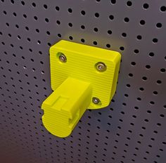 a yellow object is mounted on a metal surface with perfored holes and rivets