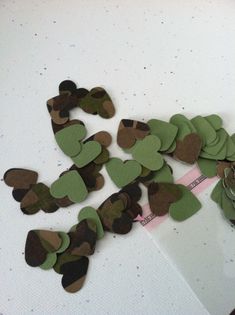 several pieces of paper with hearts cut out of them on top of a white table