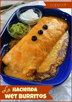 an enchilada with black olives and guacamole