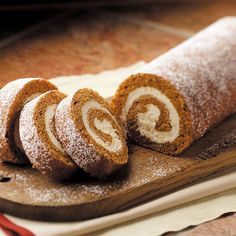 cinnamon roll on a cutting board with powdered sugar