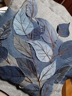 blue leaves are on the back of a chair