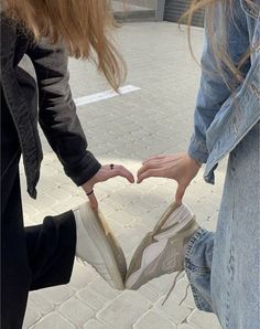 two girls are holding onto each other's shoes