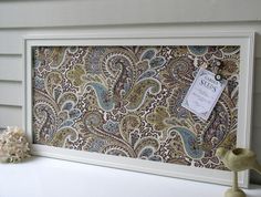 a white frame with a paisley print on it