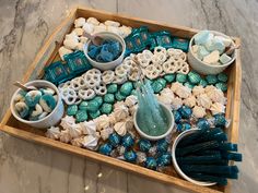 a tray filled with candy and candies on top of a table