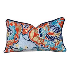 an orange and blue floral pillow on a white background with the word's name