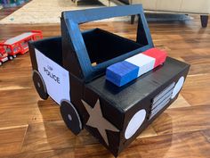 a cardboard box shaped like a race car with a flag on the front and side