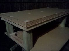 an unfinished table is shown in the dark