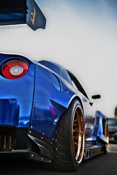 the rear end of a blue sports car