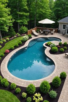 a backyard with a pool and patio furniture in the middle, surrounded by lush green trees