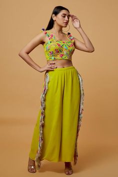 Lime green blouse with floral thread embroidery and tassels. Comes with tassel detail pant. - Aza Fashions Festive Green Pant Set With Floral Embroidery, Green Embroidered Palazzo Set For Summer, Embroidered Green Palazzo Set For Summer, Green Embroidered Pant Set For Summer, Summer Embroidered Green Palazzo Set, Spring Embroidered Sleeveless Palazzo Set, Fitted Tassel Sets For Spring, Fitted Sets With Tassels For Spring, Fitted Spring Sets With Tassels