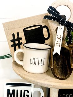 two coffee mugs are sitting on a shelf next to each other with tags attached