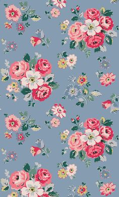 a blue floral wallpaper with pink and white flowers on the bottom half of it