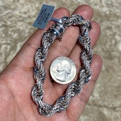 Men's iced rope chain hip hop bracelet. 14k white gold plated over a brass core. High quality frosty micro pave CZ stones. Nobody will know its not real diamonds. Bracelet is 8.5" inches long x 10MM thick. Solid rope chain bracelet weighs 42 grams. Features a stylish luxury clasp to lock it. Piece looks and feels like a million bucks. Gems shine so hard they will blind you. Buy confidently with 30 day guarantee. 100% FREE SHIPPING in USA. Order now! Iced Out Diamond Cuban Link Bracelet, Silver Iced Out Cuban Link Bracelet With Cubic Zirconia, Silver Iced Out Cuban Link Cubic Zirconia Bracelet, Silver Iced Out Cuban Link Bracelet, Iced Out Silver Cuban Link Bracelet, Iced Out White Gold Cuban Link Bracelet, Iced Out Diamond Bracelet, Diamonds Bracelet, Mens Bracelet Silver